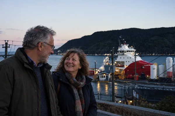Couple chatting above the harbour in St. Johns at dusk