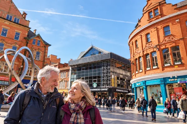 Couple in Belfast city centre beside the Spirit of Belfast sculpture