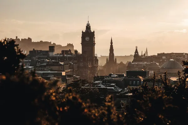 Edinburgh skyline at sunset with the Balmoral clock tower and the castle